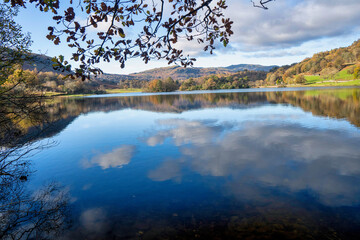 Naklejka na ściany i meble Magnificent scenery of Lake district national park with reflections on the water showing the beautiful colors of autumn. 