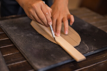 Hands of girl works with clay in modern pottery workshop. Hobbie