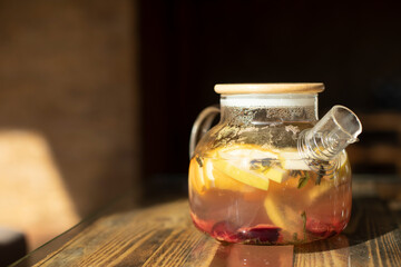 Teapot with fruit. Transparent tableware. Healthy drink.