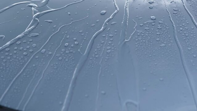 Water drops rolling off car