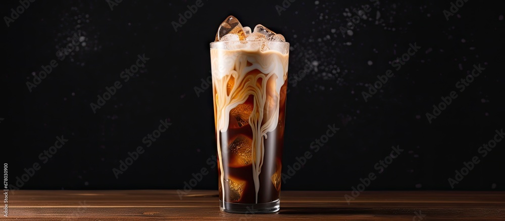 Sticker Cream is poured over iced coffee in a tall glass Copy space image Place for adding text or design