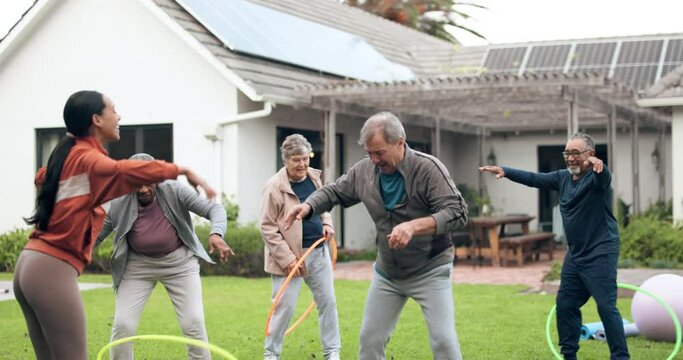 Class, physiotherapy and fun with old people and hoop for support, health and challenge. Wellness, rehabilitation and coaching with personal trainer in nursing home for energy, fitness and retirement