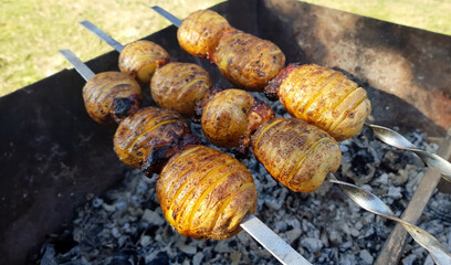 Potato skewers with crispy crust is fried on grill. Healthy eating concept