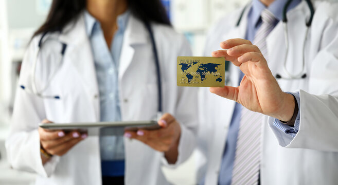 Group of medics presenting to visitor special member card for easy payment close-up