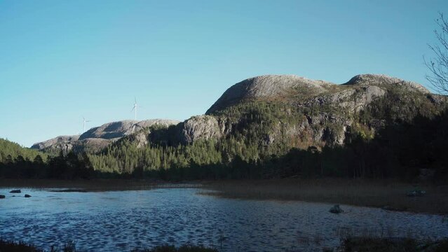 Hildremsvatnet, Trondelag, Norway - Magnificent Vista of a Lake, Vegetation, Mountains, and a Distant Windmill - Static Shot