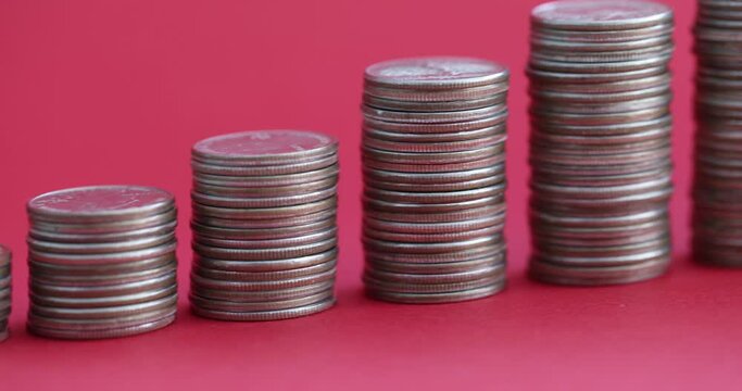 Stacks of coins ascending with piggy bank on red background. Increasing investment in fixed assets concept