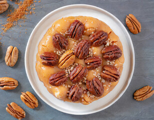 On a dessert platter, a top-down shot of a Southern pecan praline captures the sugary, caramelized goodness of pecans coated in a sweet and buttery confection, embodying the indulgent flavors of the A
