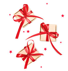 three small Christmas gifts and star shaped confetti on a white isolated background