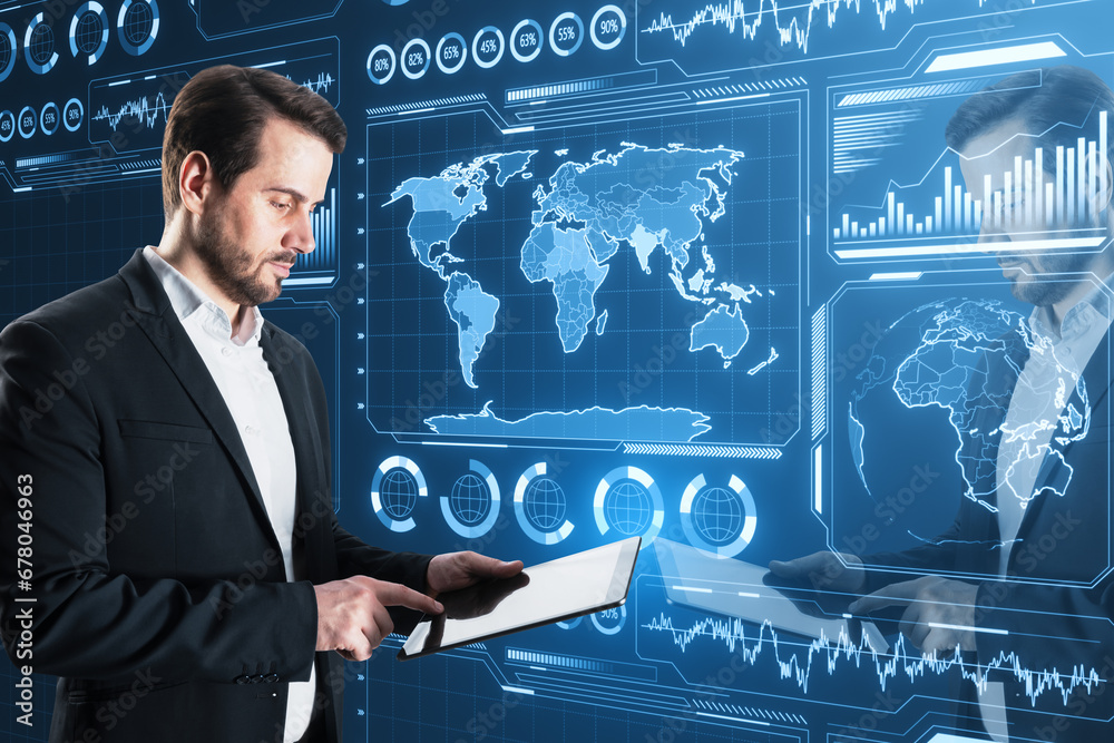 Poster Attractive young businessman using tablet with glowing digital business charts and map interface on blurry background. Military control, warfare and spy concept.