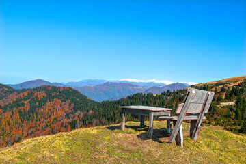 Bench located in the field on the green hill. Hill and bench with forest view.
Picnic seating area at Sal Plateau. Rize, Türkiye.