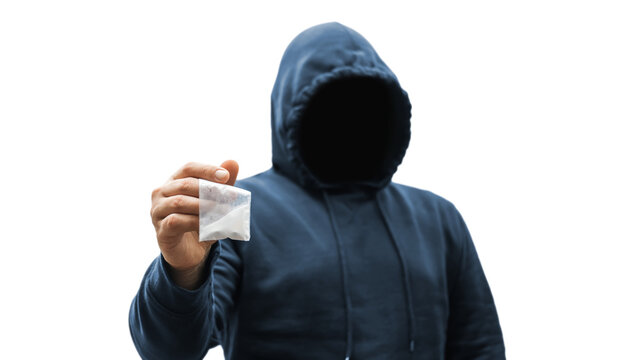 Faceless man in a hood holds transparent plastic bag with white powder hard drugs isolated on transparent background, anonymous drug dealer or gangster sells narcotics