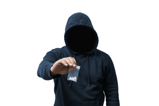 Faceless man in a hood holds transparent plastic bag with white pills hard drugs on transparent background, anonymous drug dealer or gangster sells narcotics