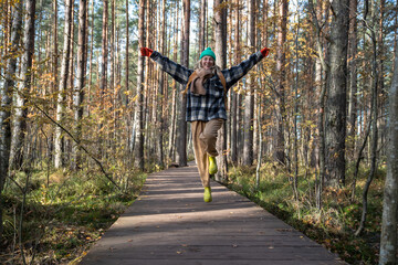 Glad, glowing with pleasure middle-aged woman delighted with sunny autumn day having rest in...