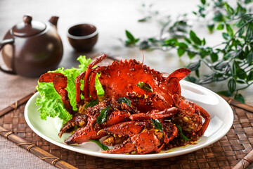 traditional chinese wok fried seafood fresh big meat crab with black pepper spicy sauce in plate on...