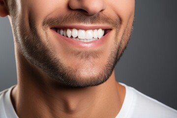 A close up man smiling showing clean teeth
