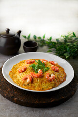 traditional chinese stir fried seafood fresh big tiger prawn with omelette egg in plate on grey vintage background asian cafe hotel luxury halal food restaurant banquet menu