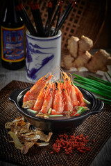 traditional chinese seafood big tiger fresh prawn with herbal premium sauce in clay pot on grey vintage background asian cafe hotel luxury halal food restaurant banquet menu