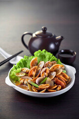 traditional chinese wok fried seafood fresh clam Lala with spicy chilli sauce in plate on grey vintage background asian cafe hotel luxury halal food restaurant banquet menu