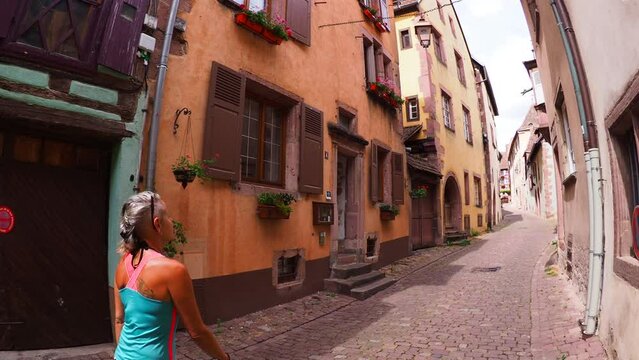 Moving through the colorful half timbered building in the streets of the beautiful Alsace village Riquewihr