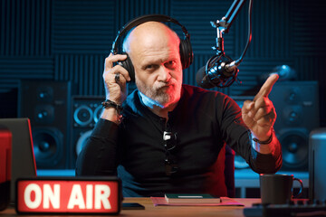 Radio host listening to music
