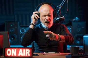 Confident radio DJ talking into the mic