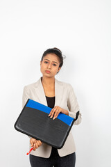 Corporate office lady holding a folder, pen and giving presentation. Young woman in formal wear wearing white blazer against white background.