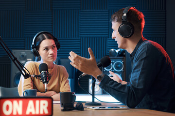 Radio host interviewing a guest in the studio
