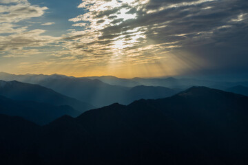 Rays of sunlight reflected from the clouds to the mountains.Rays of sunlight reflected from the...