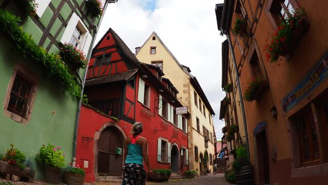 Moving through the colorful half timbered building in the streets of the beautiful Alsace village Riquewihr