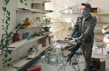 Man doing grocery shopping in a destroyed supermarket interior
