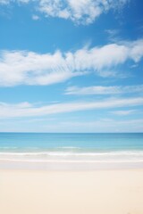 Fototapeta na wymiar Serene beach scene with soft sandy shore, ocean waves, and a blue sky with fluffy clouds. Vacation mood that speaks of tranquility and relaxation. Peaceful holiday. Relax in the nature
