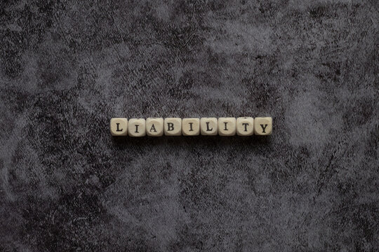Liability concept, liability word from letters on black
