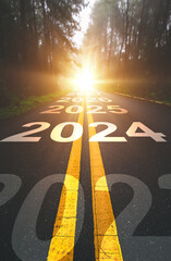 Vertical, 2024 New Year road trip travel and future vision concept . Nature landscape with highway road leading forward to happy new year celebration in the beginning of 2024 for fresh  - obrazy, fototapety, plakaty