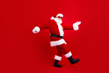 Fototapeta na wymiar Full size photo of optimistic funky nice grandfather wear santa costume in glasses dancing having fun isolated on red color background