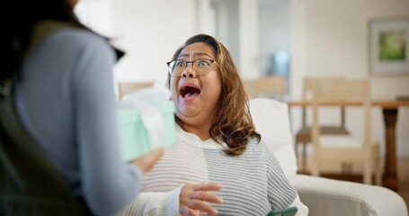 Child, mom and giving gift box with surprise, wow and celebration, hug and thank you at home. Happy or excited family for mothers day and girl offer present or package on sofa with hug, love and care