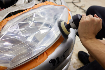 Big headlight cleaning on the car with power buffer machine at service station ,Before and after...