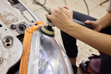 Big headlight cleaning on the car with power buffer machine at service station ,Before and after...