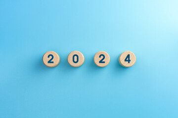 Wooden blocks with 2024 icon on blue background