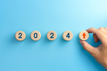 Wooden blocks with new year 2024, arrow up icons, Business development and growth 2024 concept