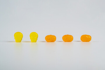 Colorful Fruity Gummy Worm Candy on white background.