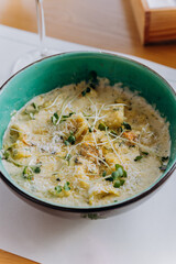 Tasty Mussels in cheese sauce with dumplings served with greens. Restaurant menu