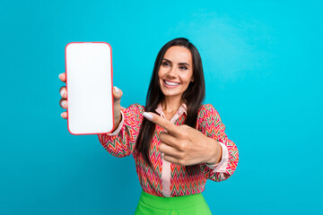 Photo of lovely young lady hold point device white touch screen dressed stylish print garment isolated on aquamarine color background