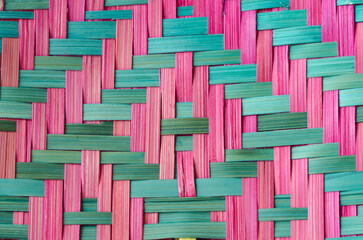 Close up pink and green bamboo basketry woven pattern background. - obrazy, fototapety, plakaty