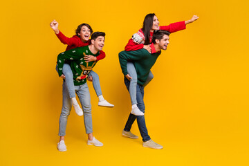 Fototapeta premium Photo of positive fellows lady guys piggyback have competition activity on christmas party isolated over bright color background