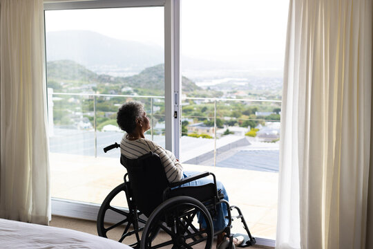Senior african american female patient in wheelchair by window