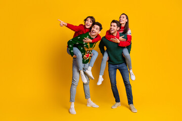 Fototapeta premium Photo of best friends guys piggyback ladies demonstrate tradition seasonal christmas adverts isolated over bright color background