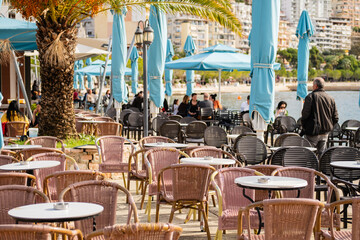 Modern restaurant terrace by the sea. Outdoor restaurant at the beach with table and chairs