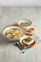 traditional chinese set seafood fried putian noodle with dumpling dim sum bao and soup snack vegetable in plate on grey vintage background cafe hotel luxury halal food restaurant banquet menu