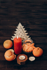 Candles for Christmas decoration, festive attributes and mandarin place for text
