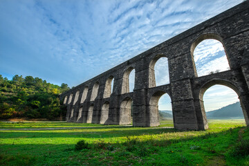 Fototapeta na wymiar Güzelce Aqueduct built in Istanbul by the Master Ottoman Architect Sinan. Güzelce Aqueduct One Element of Kırkçeşme Waterway of Great Sinan. 